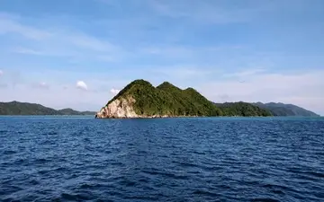 A peaceful river flowing towards the sea, captured by Tasveer